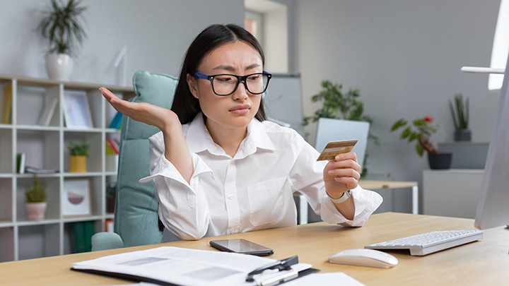 Young woman holding credit card